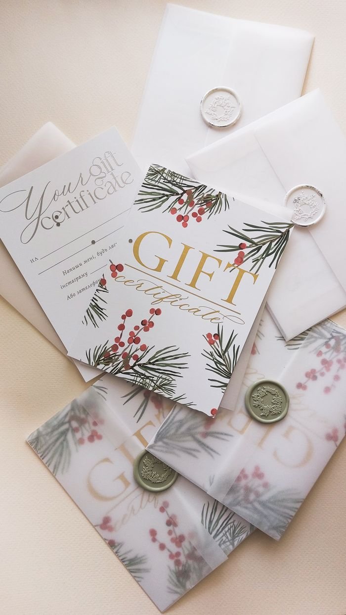 services-03 Stylish arrangement of holiday-themed gift certificates with envelopes and wax seals.