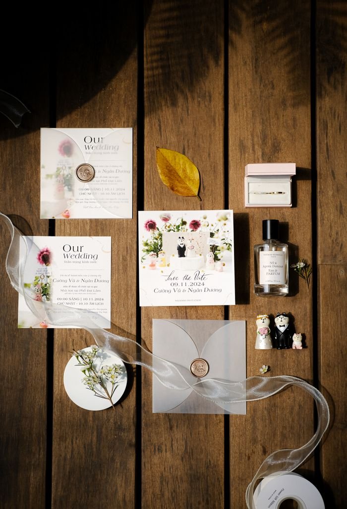 services-02 Stylish wedding invitation set arranged with perfume and decor on wooden background.