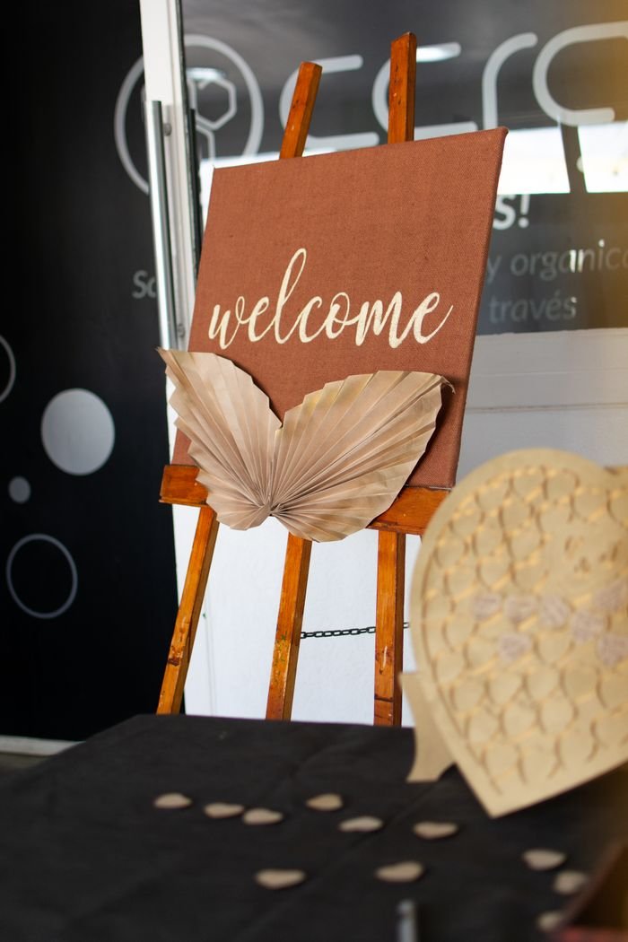 Elegant welcome sign with leaf decoration, perfect for indoor events or receptions.